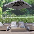 Outdoor Sofa Set With Coffee Table And Umbrella On Garden Patio With Green Plants