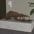 Natural Wooden Sculpture Displayed On White Striped Pedestal With Perforated Wall And Green Leaves