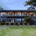 Modern Detached Villa With Large Glass Windows Lush Greenery And Lawn