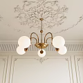 Elegant Golden Chandelier With White Spherical Bulbs And Intricate Ceiling Carvings