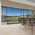 Modern Bright Open Living And Dining Space With Large Floor Glass Windows Overlooking Lush Scenery