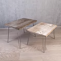Two Wooden Top Metal Leg Stools Against Grey Wall On Wooden Floor