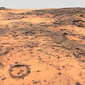 Red Desert Landscape With Rocky Terrain And Circular Patterns On Sandy Surface 3d model