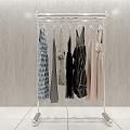 Modern Chrome Clothing Rack With Stylish Dresses And Shirts On