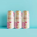 Three Tsingtao Beer Cans With Pink And White Patterns On Light Blue Background