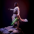 Iconic Star Wars Film Character Luke Skywalker In White Robe Holding Green Lightsaber On Rock
