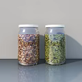 Two Glass Spice Jars With White Lids Filled With Brown And Green Spices