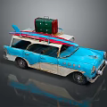 Vintage Blue Station Wagon with Surfboard and Green Suitcase on Roof