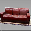 Luxurious Three Seater Red Leather Sofa On Decorative Rug In Living Room