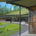 Modern Visitor Center with Lake Reflection and Scenic Grassland Near Hills Under Cloudy Sky