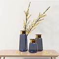 Blue Vases With Gold Rims Holding Yellow Blossom Branches On Wooden Table With Scattered Flowers