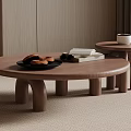 Two Round Modern Wooden Coffee Tables with Pastries Book and Cup in Living Room