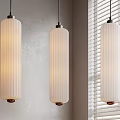 Three White Vertical Ribbed Pendant Lights with Frosted Glass Hanging in Gray Room with Blinds