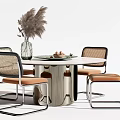 Modern Dining Table Set With Wooden Top Metal Legs Woven Chairs And Pampas Grass Vase