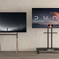 Two TVs With Wooden Legs And Silver Rolling Stand Displaying Space And Dune Scenes
