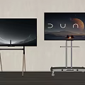 Two TVs With Wooden Legs And Silver Rolling Stand Displaying Space And Dune Scenes