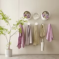 Soft Colored Hanging And Rolled Towels In White Wall Containers With Green Plant