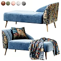 Blue Chaise Lounge With Patterned Upholstery Throw Pillow Blanket And Wooden Legs