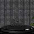 Garden Ornament Featuring Circular Fountain With Water Splashing Against Gray Striped Wall And Green Shrubs
