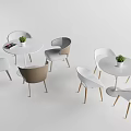 Modern Dining Table And Chair Set With Round Top Colored Seats And Potted Plants