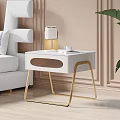 Elegant Modern White Nightstand with Gold Legs Lamp Cup Book Beside Sofa and Plant
