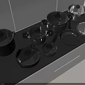 Modern Kitchen Cookware Collection With Black Pots Pans And Lids On Countertop