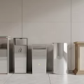 Various Stylish Waste Bins In Different Materials Against Modern Tile Wall