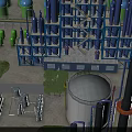 Modern Industrial Plant Exterior With Blue Steel Towers Green Storage Tanks And Large White Tank