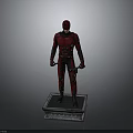 Red Superhero Statue Standing On Square Base With Red Costume And Daggers