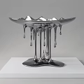 Silver Sculpture With Dripping Effect Bowl Shaped Top On White Plinth
