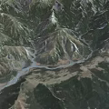 Breathtaking Aerial Natural Scenery Of Lush Mountain Ranges With Meandering River And Dense Green Forests