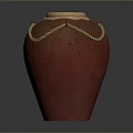 Carved Red Pottery Jar Sculpture With Rope Decoration And Light Colored Lid
