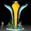 Modern Sculptural Installation With Yellow Body Blue Glowing Sides And Green Plants Around