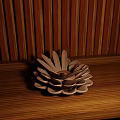 Decorative Flower Shaped Ornament Set On Wooden Tabletop With Striped Wall
