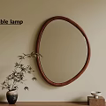 Oval Mirror With Brown Frame On Beige Wall Table Lamp And Bamboo On Wooden Table