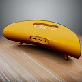 Yellow Curved Headphone Speaker on Wooden Table with Support Feet Buttons and Ports