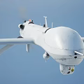 White Unmanned Fighter Drone Flying High In Sky With Long Wings And Payload