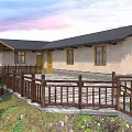 Rural Self-built House With Black Roof Stone Pavement And Curved Road Green Trees Wooden Fence