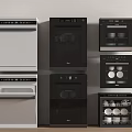 White And Black Kitchen Appliances Including Dishwasher Oven And Sterilizer Neatly Arranged Against Wall