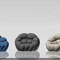 Rounded Puffy Single Chair With Blue Gray Beige Fabric And Smooth Reflective Floor