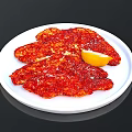 Spicy Seasoned Meat Slices Served On White Plate With Lemon Wedge
