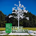 Popular Photo Check in Spot Featuring White Tree Sculpture Green Background and Circular Stone Pavement
