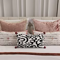 Stylish Decorative Throw Pillows With Pink Velvet Black White Patterns And Pom Poms On Bed