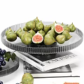 Fresh Ripe Figs and Purple Grapes on Transparent Glass Plates with Books Underneath