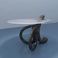 Modern Coffee Table With Round White Tabletop And Unique Black Curved Legs