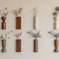 Minimalist Wall Decor With Various Shaped Vases Holding Dried Flowers On Beige Wall