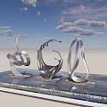 Three Silver Metal Abstract Curved Sculptures on Reflective Platform Under Blue Sky with White Clouds