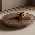 Round Wooden Coffee Table With Bowl Of Nuts And Scattered Nuts On Carpet