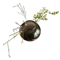 Round Glass Vase With Green Leaves And Small Branches Floral Arrangement