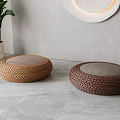 Round Woven Floor Cushions With Pink Gray Tops In Modern Room Setting